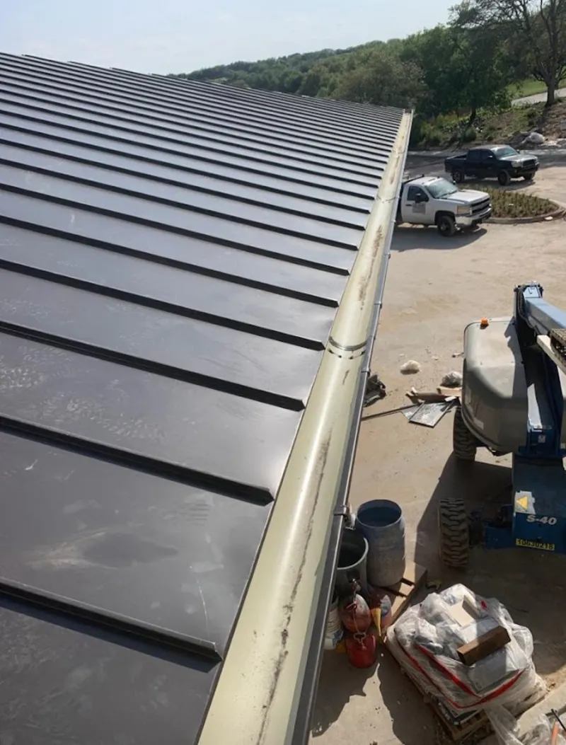Standing seam panel and gutter detail on a metal roofing jobsite in Franklin